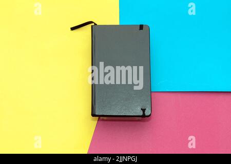 Black leather journal notebook diary on colorful background Stock Photo