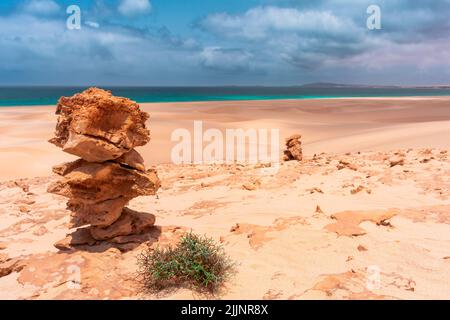 A closeup of stacked rocks on the beach Stock Photo