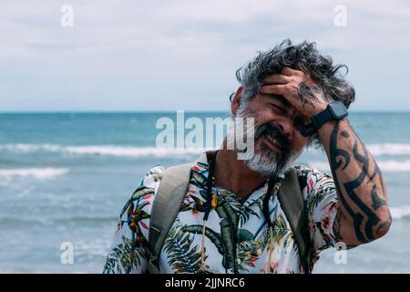 Portrait of a modern middle aged man in casual shirt on the beach Stock Photo