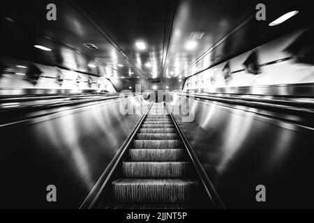 a photo in grayscale of subway escalators Stock Photo