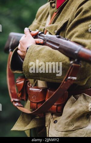 A view of a soldier with a gun on a blurred background Stock Photo