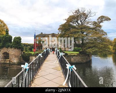 A beautiful view of bridge over the lake in Waterton Park hotel in autumn Stock Photo