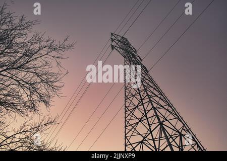 A low angle of electrical power tower under a beautiful sunset sky in Glabais, Belgium Stock Photo