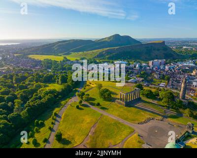 Holyrood Park and Holyrood Palace aerial view from Calton Hill in Edinburgh, Scotland, UK. Old town Edinburgh is a UNESCO World Heritage Site since 19 Stock Photo