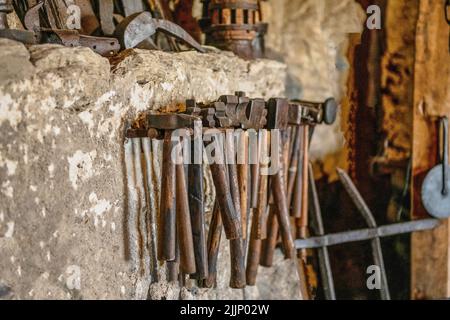 Close-up of Blacksmith Hammers hanging on a wall Stock Photo