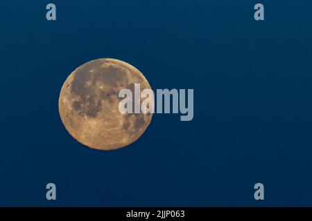 A closeup shot of a full moon on the blue background Stock Photo