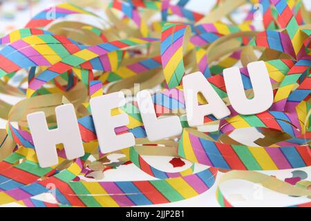 The word Helau on colorful streamers and confetti isolated on a white background Stock Photo