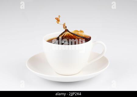 A  coffee splash from a cup isolated on white background Stock Photo