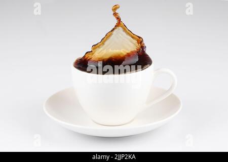 A coffee splash from a cup isolated on white background Stock Photo