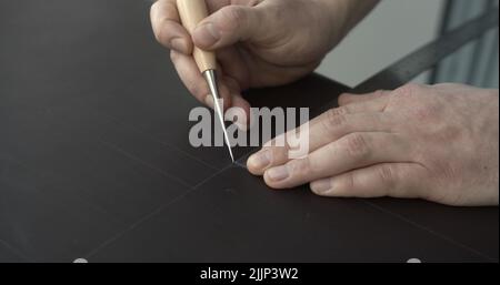 Working process of crafting a bew handmade leather wallet in the leather workshop. Concept of small business to create leather products. Horizontally Stock Photo