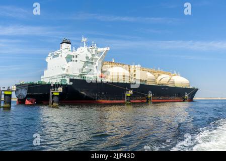 Large tanker ship for transporting liquefied natural gas in a harbour on a clear summer day Stock Photo