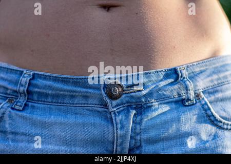 Denim material  a piece of clothing  fragment of the body Stock Photo