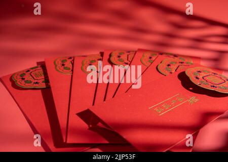 A number of red envelopes for Chinese New Year decorations on a red background Stock Photo