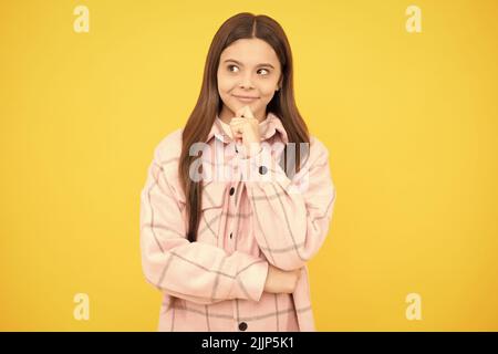 thoughtful kid girl wear pink checkered shirt, decision Stock Photo