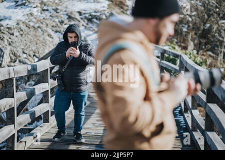 A Two young males taking photos outdoors Stock Photo