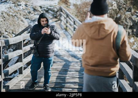 A Two young males taking photos outdoors Stock Photo