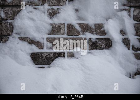 closeup photo of brick wall covered with snow Stock Photo