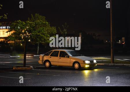 A view of parked Ford Sierra classic street car at night Stock Photo