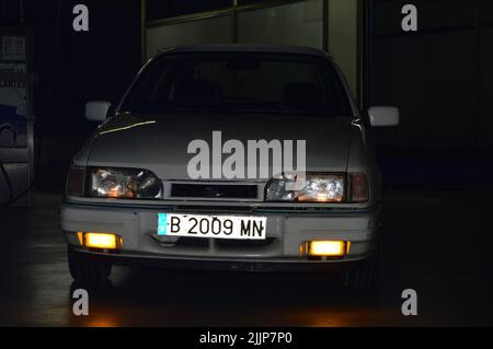 A view of parked Ford Sierra classic street car at night Stock Photo