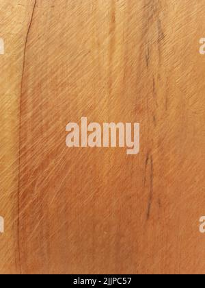 A vertical shot of a wooden surface with scratches on it Stock Photo