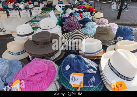 England, Dorset, Christchurch, Christchurch Market, Clothing Stall display of Hats Stock Photo