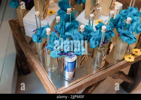 A high angle shot of beautifully decorated bottles for a wedding event Stock Photo