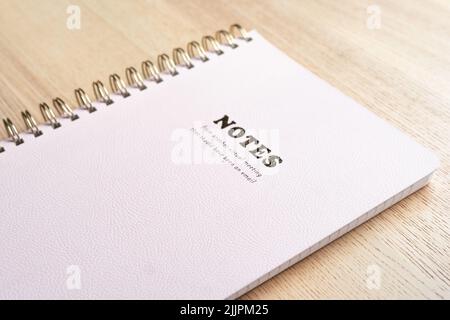 Notebook lying on the table with, pink, office supplies Stock Photo