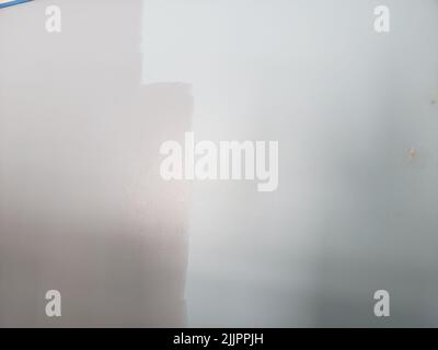 A closeup shot of a half-painted wall Stock Photo