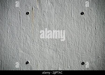 A white wall with four holes Stock Photo