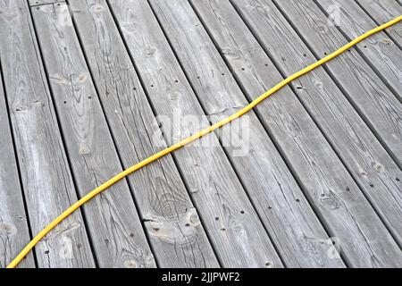yellow power cable on vintage dry wooden surface, modern electric tools diversity Stock Photo