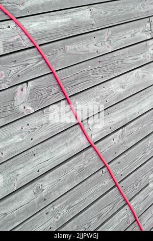 red power cable on vintage dry wooden surface, modern electric tools diversity Stock Photo
