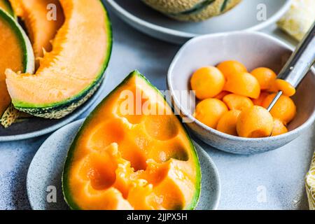 Overhead view of melon balls being prepared on a table Stock Photo