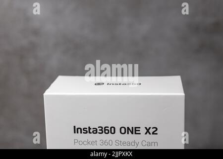 Top part of Insta360 new package camera box against a modern contemporary stylish gray background. Stock Photo