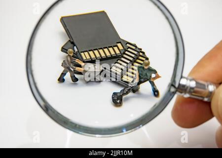 The miniature workers transferring memory cards Stock Photo