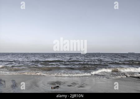 The soft ocean waves on a sandy beach Stock Photo