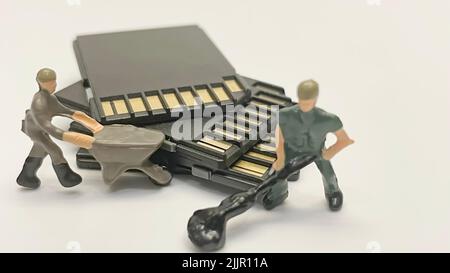 The miniature workers transferring memory cards Stock Photo