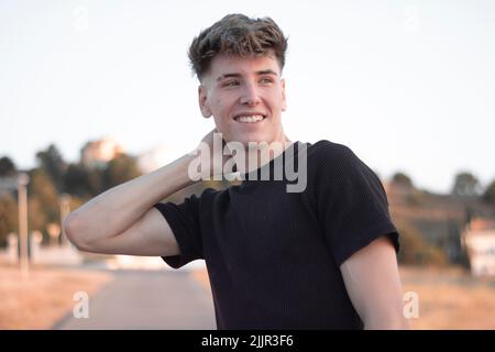 A blonde Spanish man smiling and looking away Stock Photo