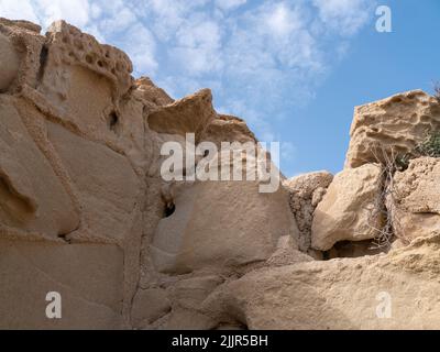A low angle shot of a rocky cliff in a blue sky on Tabarca Island in Alicante, Spain Stock Photo