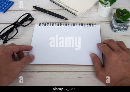 Hand holding blank white notepad with space customizable for text or ideas. Copy space Stock Photo