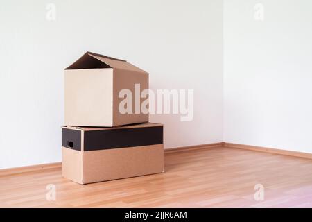 The two small cardboard boxes in the empty room Stock Photo