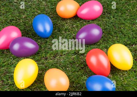 The artificial colored eggs on the grass - Easter concept Stock Photo