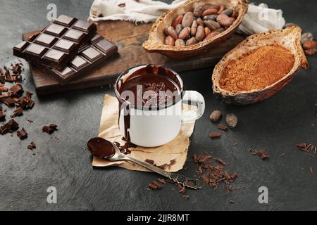 Melted chocolate drink on dark background. Hot beverage. Stock Photo