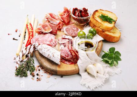 Sausages assortment on light background. Meat product made of finely chopped and seasoned meat. Stock Photo