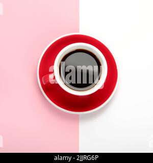 Coffee in red cup on color background. Hot beverage. Top view, flat lay, copy space Stock Photo