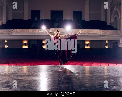 Staying graceful under pressure. a ballerina performing her routine in a theater. Stock Photo