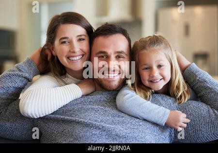 My two favourite girls. a young family relaxing on the couch at home. Stock Photo