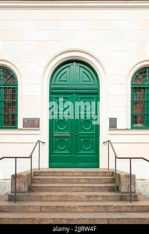 A vertical shot of a green entrance door of a building in Ludwigstrasse, Munich, Germany Stock Photo