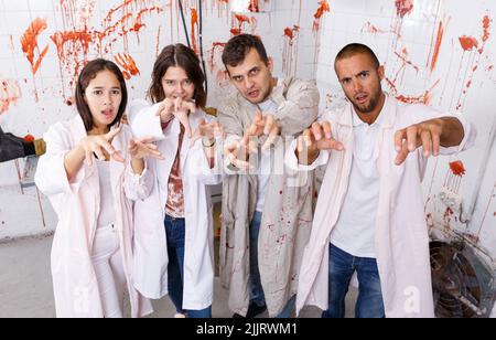 Friends with outstretched hands like zombies Stock Photo