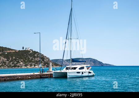 Sailing catamaran moored at sea pier on Mediterranean sea Stock Photo