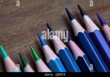 Color pencils in a cool tone on the wooden floor Stock Photo